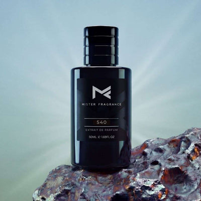 Dark glass perfume bottle with black cap, label reading 540 and Extrait de Parfum.